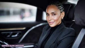 Professionally dressed businesswoman sitting in the backseat of an executive sedan, enjoying a chauffeured ride.
